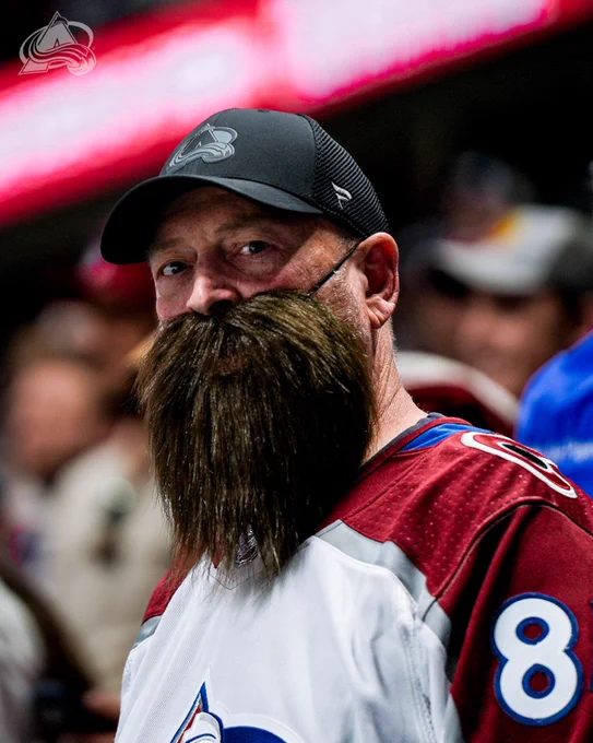 An Avalanche fan with a beard strapped on his face to look similar to Brent Burns