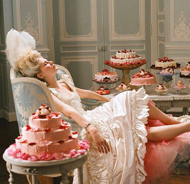 kthnoir7's tweet photo. If the figure on the cake is Marie Antoinette, then this scene becomes one of the darkest metaphors in Normal.

A cake is meant to be admired, celebrated, shared, and ultimately consumed. The moment the knife cuts into it, the image begins to disappear. That mirrors celebrity almost perfectly. 

Society creates an icon, places them on a pedestal, celebrates them, and then slowly consumes them until nothing remains but the image they projected.The Normal MV already questions what it means to perform "normal." 

A birthday cake is one of the most ordinary symbols of celebration, yet instead of a name or birthday message, its centerpiece is Marie Antoinette—a historical figure whose legacy has been shaped as much by myth and public perception as by reality. 

She's become less of a person and more of a symbol.
It's almost as if the celebration isn't for the individual at all, but for the persona people have created.

 They're not celebrating the person—they're celebrating the story, the image, the spectacle.What makes the scene even more unsettling is where the knife lands. It cuts directly through the center of Marie Antoinette, almost like a surgical incision. 

Throughout Normal, BTS blur the line between identity and perception, between who they are and who the world believes them to be. Cutting through her image feels like an attempt to dismantle that illusion. 

Before you can reach what's real, you have to destroy the version everyone has been consuming.Marie Antoinette's story also carries another layer of meaning. Whether or not every story about her is historically accurate, she has become a cultural icon remembered more for the narrative built around her than for the person she actually was. 

In many ways, that's exactly what Normal seems to be exploring: how public figures stop being seen as human beings and instead become symbols—admired, criticized, romanticized, and consumed by everyone else.