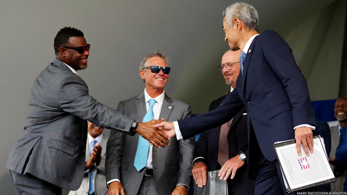 Ichiro Suzuki, right, shakes hands with Ken Griffey Jr. during the 2025 Induction Ceremony as Craig Biggio and Billy Wagner look on. (Mary DeCicco/MLB Photos)