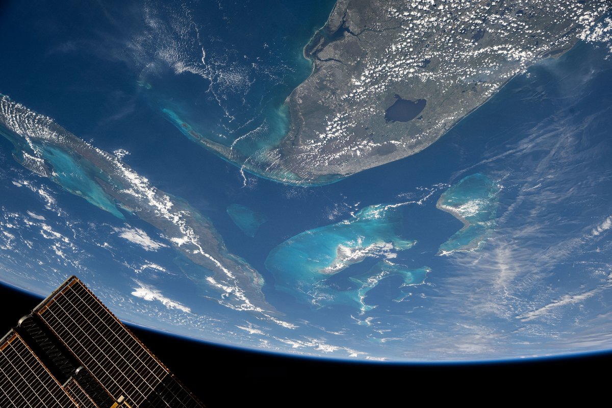 Space_Station's tweet photo. The Sun’s glint beams across the English Channel separating France and England who are competing in Saturday’s World Cup match.  Across the Atlantic, South Florida’s sunlit coastline stands out from orbit by day, while at night the region lights up with festive city life — including Miami, host of Saturday’s semifinal. 🌎🏆⚽️