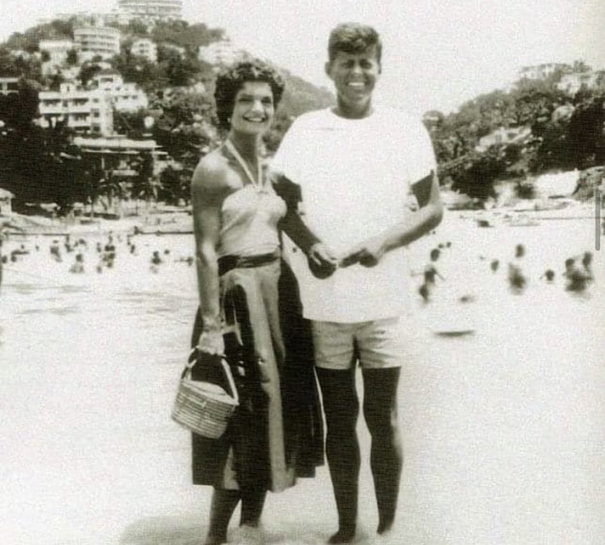 Cuauhtemoc_1521's tweet photo. En septiembre de 1953, apenas un día después de su boda en Newport, el senador John F. Kennedy y Jacqueline Bouvier llegaron a Acapulco para pasar su luna de miel.
Esta fotografía los captura en una de las playas del puerto, sonrientes, relajados y todavía lejos de la Casa Blanca. Jackie con su canasta de mimbre y Jack en playera blanca y shorts, disfrutando del sol y el mar de un Acapulco que por aquellos años era el destino favorito del jet-set internacional.
Pasaron dos semanas en el puerto guerrerense. Pocas imágenes se conservan de esa etapa, y esta es una de las más hermosas. Años después, durante su visita de Estado a México en 1962, Jackie recordaría con cariño aquella primera vez en nuestro país:
“Esta es la segunda vez que visitamos este maravilloso país… La primera fue en 1953, durante nuestra luna de miel en Acapulco”.
Un momento de pura felicidad en la época dorada del puerto.