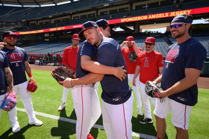 Mike Trout and Jared Grindlinger meet for the first time and hug on the Angel stadium field during batting practice.