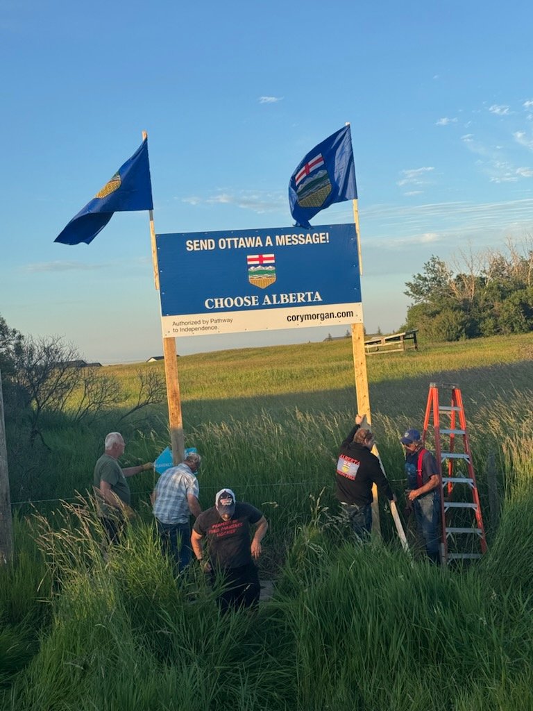 CoryBMorgan's tweet photo. A supporter off of highway 2 had one of our lawn signs &amp; was upset when it was stolen.

Our incredible sign crew showed up &amp; raise a 4x8 replacement with flags. 

Cancel clowns keep pushing us.

We keep pushing back harder.

We are Albertans. https://t.co/7EviJJBnP1