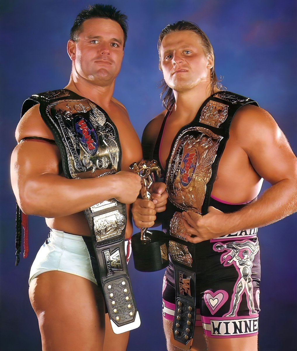 WWFWrestling1's tweet photo. Tag Team Champions of the day: British Bulldog and Owen Hart - Captured the titles at In Your House: Mind Games on September 22, 1996. Their reign lasted 246 days. 🏆 #WWF #WWE #DaveyBoySmith #OwenHart https://t.co/d7L1WrKn5a
