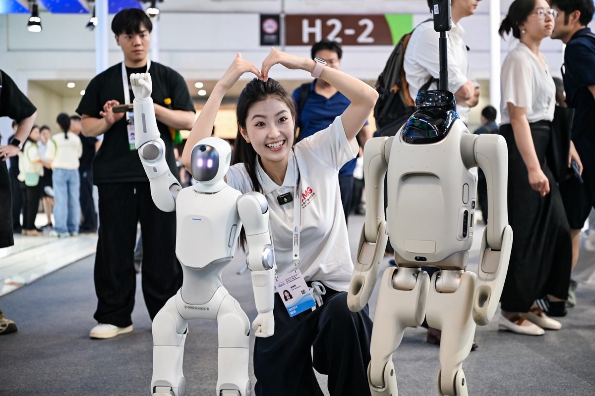 Primebotglobal's tweet photo. "Welcome to WAIC—the world's leading AI conference! I'm Q1, and T1 and I are here to guide you through it all. Let's explore the future together!" 🤖✨

Crowd reacting, pointing, watching—that's the shot. 🎬

#WAIC2026
#Q1robot
#T1robot
#PrimeBOT 
#HumanoidRobot
#Personalrobot
#Yourmateyoumade
#Robot
#Robotics