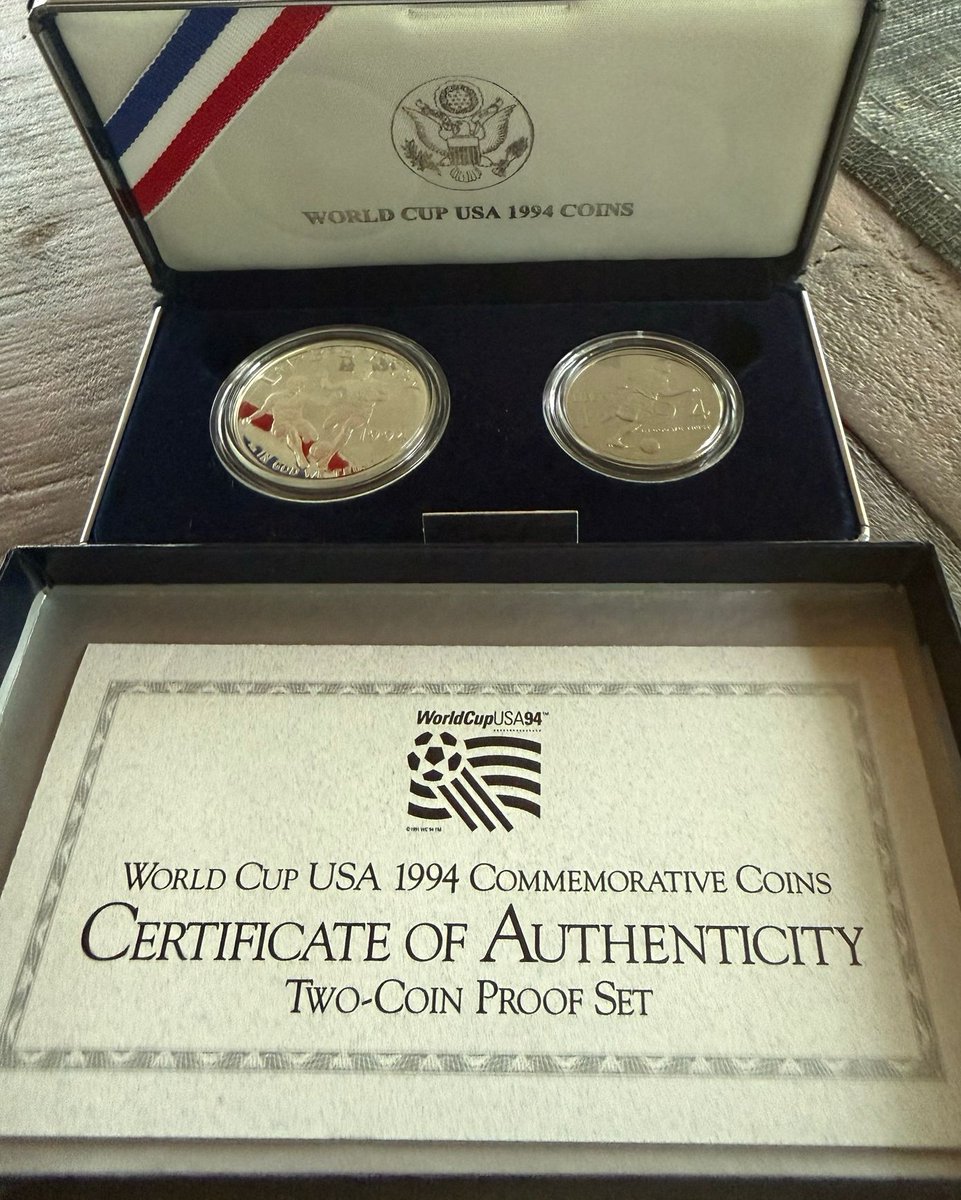 AndyKimNJ's tweet photo. I found in my basement this commemorative coin set that I bought in 1994 when I went to a World Cup game with my dad. I completely forgot about these coins, but now they’ve helped me remember a flood of memories of how excited I was as a 12 yr old watching the World Cup in America. My dad sadly doesn’t remember as he now has Alzheimer’s. But the other day I looked closely at a collage of photos hanging in his room and saw there was a photo of me and him at the game 32 yrs ago. I left the coins underneath the photo. I still have hope one day they might spark a memory for him as they did for me.
