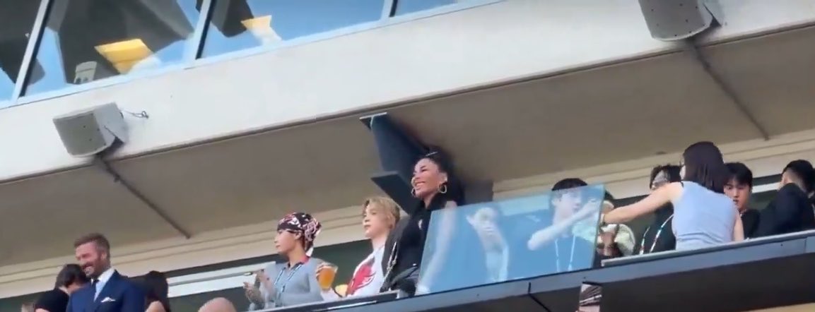 hourjinnie's tweet photo. Seokjin taking selfies while watching the game and being handed a beer! 🍺 

BTS are standing next to Tom Cruise &amp; David Beckham! 

JIN AT FIFA WORLD CUP
BTS AT WORLD CUP 2026
#BTSxWORLDCUP2026 
#BTSHALFTIMESHOW https://t.co/rXilLlEm51
