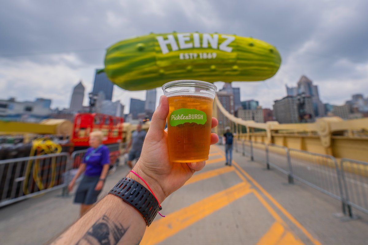 DaveDiCello's tweet photo. Earlier today I had a family photoshoot on the North Side of #Pittsburgh and after decided to make a quick stop to Picklesburgh. It was pretty packed when I left at noon, but I had to grab a pickle beer and the obligatory Picklesburgh ballon in front of the giant pickle shot. https://t.co/9S9G4PSIoS