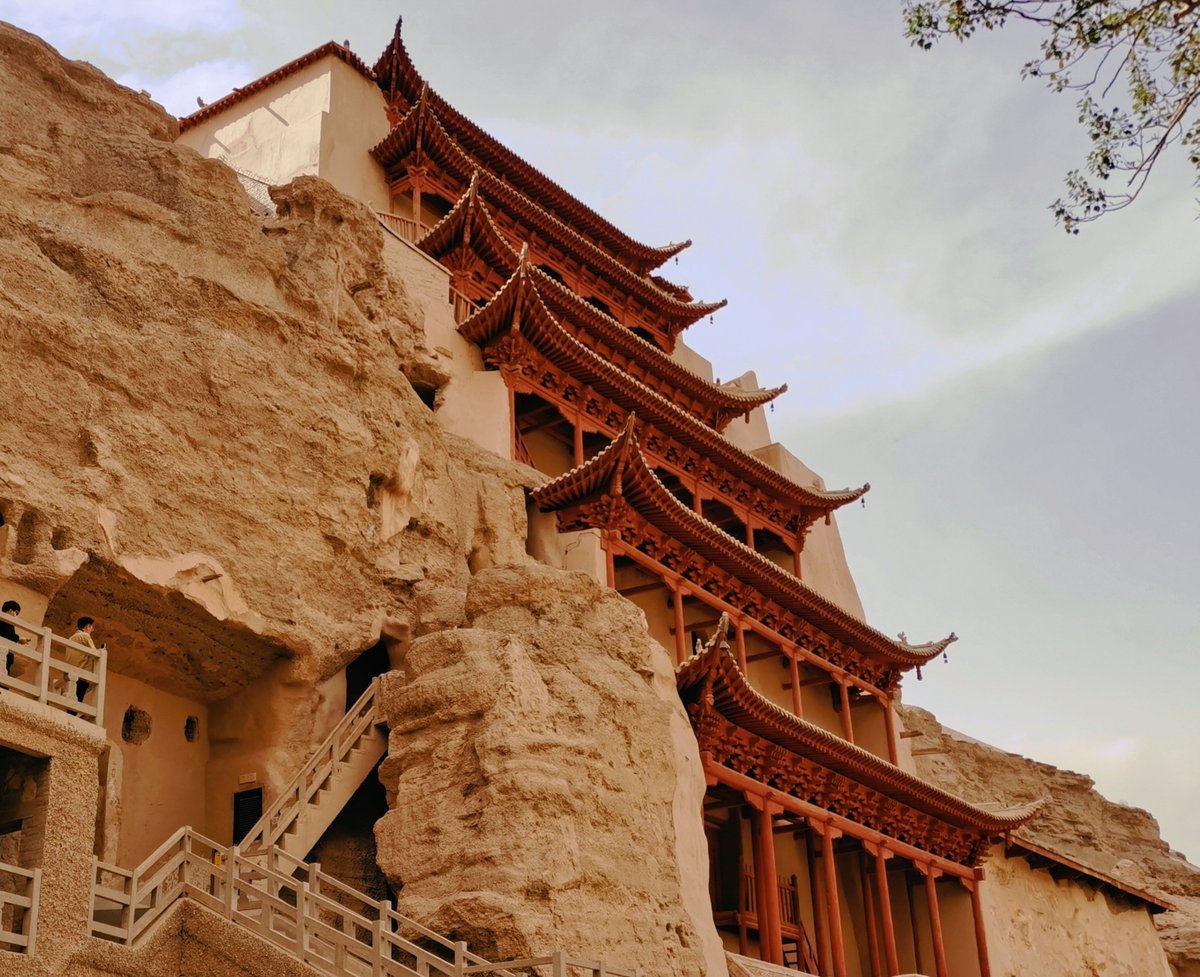 CGTNOfficial's tweet photo. #ChinaSeen Nestled in the deserts of northwest China's Gansu Province, the #UNESCO World Heritage Mogao Caves are the world's largest and best-preserved Buddhist cave art site, with a collection of 735 caves spanning a cliff face 1,700 meters long. Among them are 492 caves housing paintings and sculptures dating back to the 4th century AD. Adorned with intricate murals, sculptures and architectural designs, they bear witness to the dynamic cultural exchanges along the Silk Road.

The construction of the #MogaoCaves is generally believed to have begun sometime in the 4th century AD, when they served as places of Buddhist meditation for hermit monks. The caves continued to be expanded until the 14th century, eventually becoming places of worship and pilgrimage for the public.

The Mogao Caves, an unparalleled treasure trove of ancient art, offer invaluable insight into the evolution of Chinese art, religious beliefs and daily life over the course of a millennium. Along with the Longmen Grottoes and the Yungang Grottoes, they are one of the three great ancient Buddhist sculptural sites in China. (Photos via VCG and IC) #ChinaTravel #CivilizationsShine