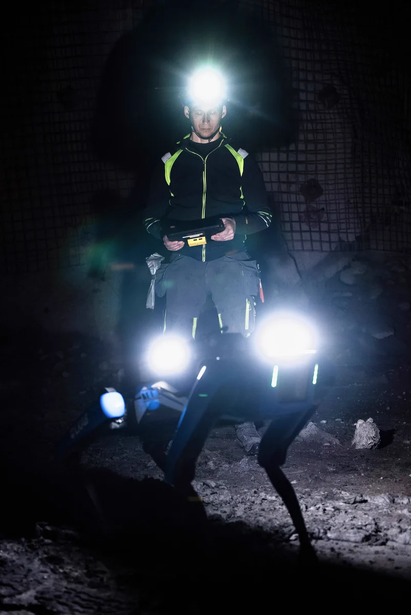 A worker operating a quadruped robot in LKAB's underground iron ore mine.