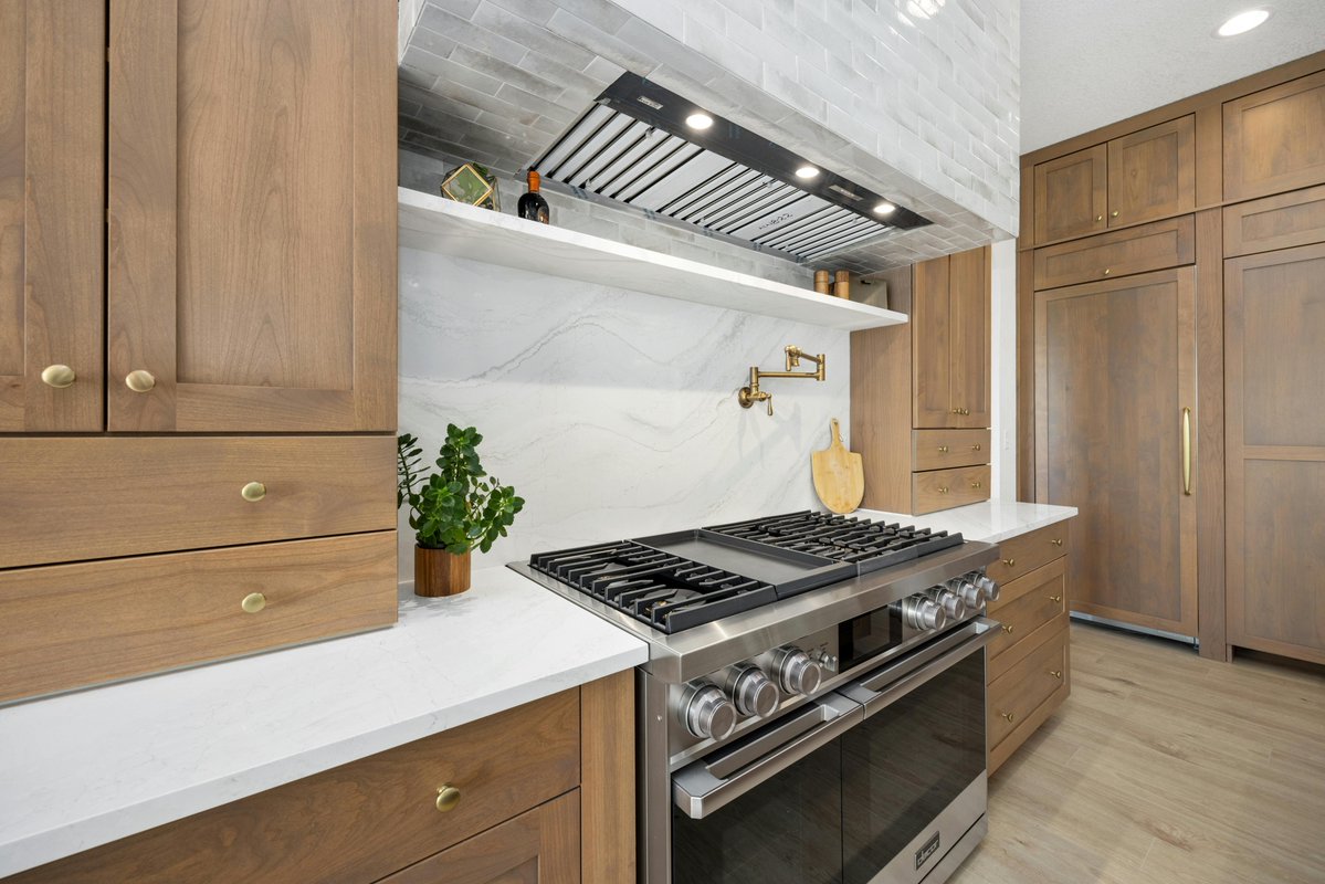 NATLdesignco's tweet photo. Every line in this kitchen was planned before a single cabinet went in. The island runs long and open so traffic moves around the cook, not through them, the range wall centers on a custom tile hood with a built-in pot filler set exactly where it earns its keep. https://t.co/pSOY7bO8IF