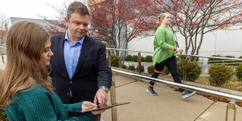 Jacob Rammer, an assistant professor of biomedical engineering, works with a student on a mobility test at the University of Wisconsin-Milwaukee.