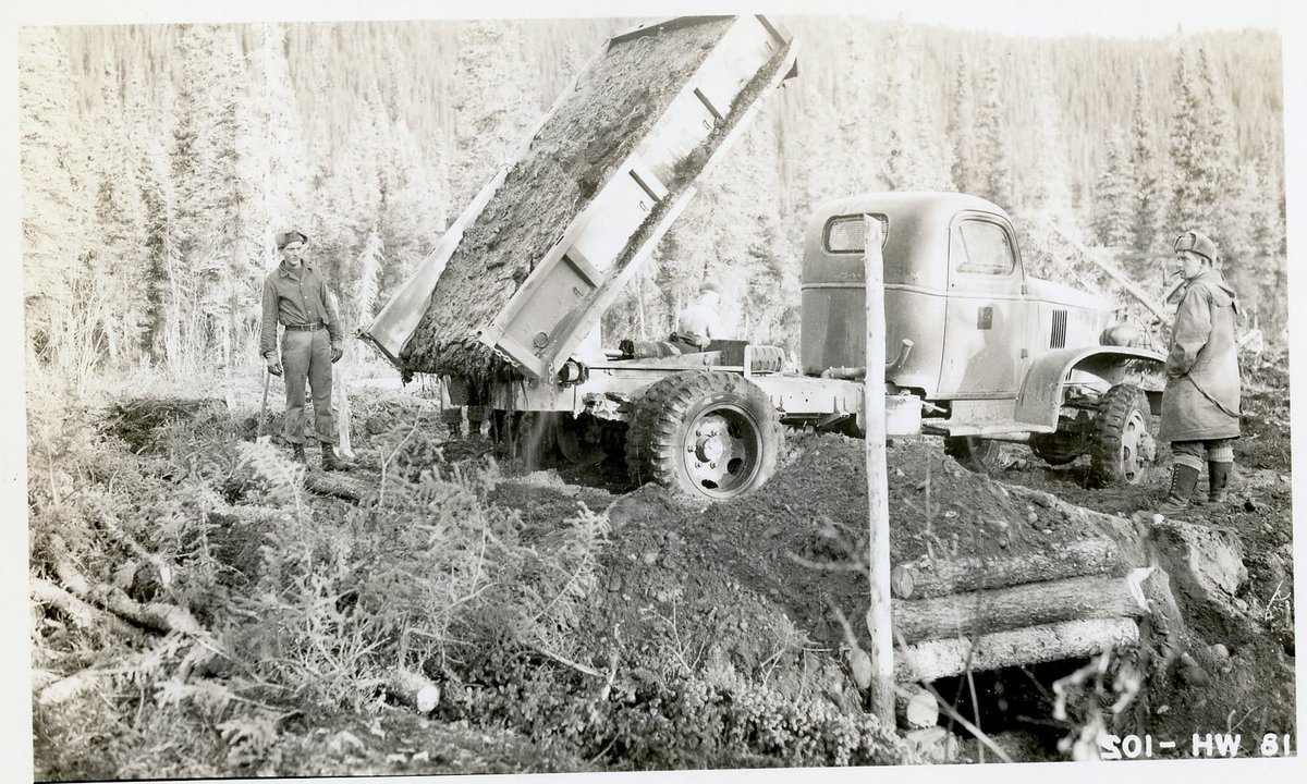 ANC_Historian's tweet photo. Oct 15, 1942, soldiers try to dump a load of gravel or dirt in the construction of the Alcan Highway, but the load is frozen in the truck. Via National Archives. #alaskahistory #cdnhist #alaska https://t.co/MOf8ZJfP7D