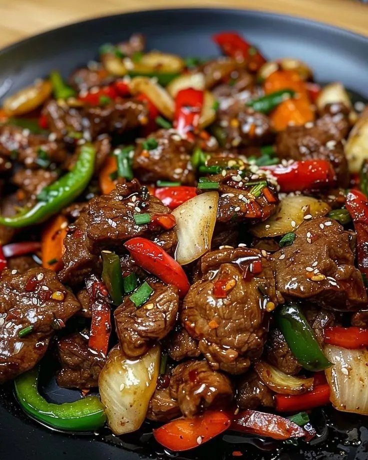 ann_ann886's tweet photo. Black Pepper Beef Stir-Fry

Ingredients
Beef and marinade
1.25 lb (560 g) beef sirloin, flank, or tri-tip, sliced 1/4-inch against the grain
1 tbsp light soy sauce
1 tbsp Shaoxing wine (or dry sherry)
1 tsp dark soy sauce (color, optional)
1 tsp sugar
1/4 tsp baking soda (tenderizes)
1 tsp cornstarch
1 tbsp neutral oil (to velvet)
Vegetables
1 medium onion, cut into 1-inch petals
1 red bell pepper, sliced
1 green bell pepper, sliced
2–3 scallions, 1-inch pieces
2 cloves garlic, minced
1 tsp fresh ginger, minced (optional)
Sauce
2 tbsp oyster sauce
1 tbsp light soy sauce
1 tbsp coarse freshly ground black pepper (adjust to taste)
1 tsp dark soy sauce (depth, optional)
1 tsp sugar
1 tsp rice vinegar (or black vinegar)
1/2 cup low-sodium beef stock or water
1–1.5 tsp cornstarch
1 tsp sesame oil
For the wok
2–3 tbsp neutral high-heat oil
Toasted sesame seeds and extra cracked pepper for finish (optional)

Instructions
Marinate the beef
Toss beef with light soy, Shaoxing, dark soy, sugar, baking soda, and cornstarch. Mix until tacky, then drizzle in 1 tbsp oil to coat. Rest 15 minutes at room temp.
Make the sauce
Whisk oyster sauce, light soy, black pepper, dark soy, sugar, vinegar, stock, cornstarch, and sesame oil until smooth. Set by the stove.
Sear the beef
Heat a wok or large skillet over high until just smoking. Add 1–1.5 tbsp oil, swirl, then spread half the beef in a single layer. Sear 45–60 seconds, flip, and cook just until no longer red (about 60–90 seconds total). Remove to a plate. Repeat with remaining beef, adding oil as needed.
Stir-fry aromatics and veg
Return wok to high heat with 1 tbsp oil. Add onion, bell peppers, and a pinch of salt; stir-fry 2 minutes until edges blister but stay crisp-tender.
Add garlic (and ginger) and toss 20–30 seconds until fragrant.
Sauce and finish
Return beef (and any juices) to the wok. Give the sauce a stir and pour in. Toss 30–60 seconds as it boils and glosses, coating everything. Adjust pepper and salt to taste. Fold in scallions.
Serve
Plate immediately over steamed jasmine rice or noodles. Finish with sesame seeds and an extra crack of pepper.

Tips for restaurant-style results
Slice partially frozen beef for cleaner, thin cuts.
Baking soda + cornstarch “velvets” the beef for tenderness—don’t skip.
Use very hot wok and cook beef in batches to avoid steaming.
Grind pepper coarsely right before cooking for punchy aroma.
Variations
Add mushrooms or snap peas; keep total veg to ~3 cups so the sauce stays glossy.
Swap beef with chicken thighs or firm tofu (press and cornstarch-dust before searing).
Make-ahead
Marinate beef up to 8 hours chilled; bring to room temp 15 minutes before cooking.
Stir-fry sauce can be mixed 2–3 days ahead; shake before using.