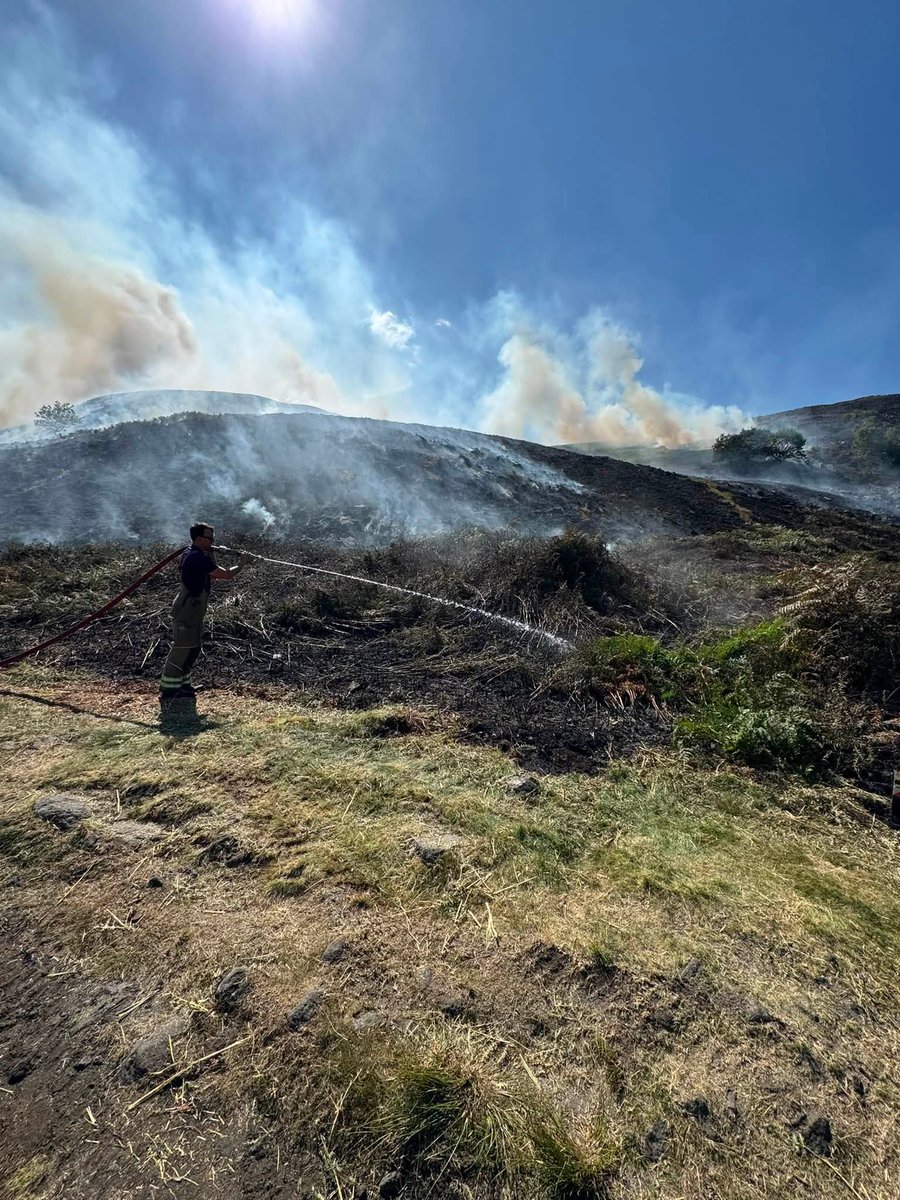 DerbyshireFRS's tweet photo. Tintwistle Moor – #UPDATE 21 July

Firefighters &amp; partners remain deployed with ongoing operations focusing on continuing to contain fire, managing hotspots, and dealing with flare-ups. Around 75 personnel on site today supported by 3 helicopters. More: https://t.co/J9N8aiu8nk https://t.co/G49FGKc9rA
