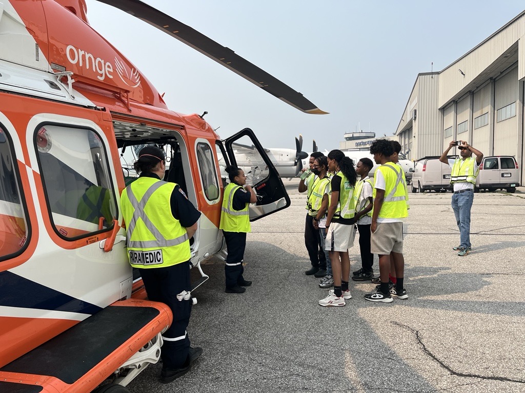 Ornge's tweet photo. This past Thursday the Shooting Stars Academy from camp visited our Toronto base. Campers heard from pilots and paramedics and what it is like to be Ontario's air ambulance service provider. 

We thank all the 799 staff who participated in the camp visit.
#teamOrnge https://t.co/AEscl64lWM