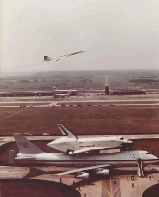 Rainmaker1973's tweet photo. An iconic 1980s photo at Dulles captures NASA’s Shuttle Enterprise atop its 747 carrier as a British Airways Concorde takes off, celebrating a golden era of aviation and space innovation. https://t.co/aAaq8YCmUW