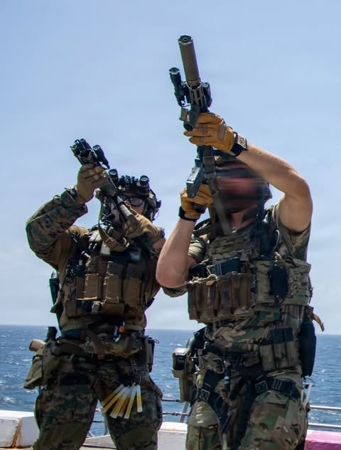 WarFlash_2630's tweet photo. U.S. Coast Guardsman, with Maritime Security Response Team East, scan for simulated enemy combatants aboard San Antonio-class amphibious transport dock USS San Antonio (LPD 17) during a Maritime Interdiction Operation Full Mission Profile rehearsal while underway in the Caribbean Sea, July 18, 2026.