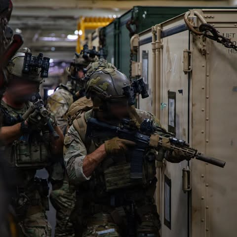 WarFlash_2630's tweet photo. U.S. Coast Guardsman, with Maritime Security Response Team East, scan for simulated enemy combatants aboard San Antonio-class amphibious transport dock USS San Antonio (LPD 17) during a Maritime Interdiction Operation Full Mission Profile rehearsal while underway in the Caribbean Sea, July 18, 2026.