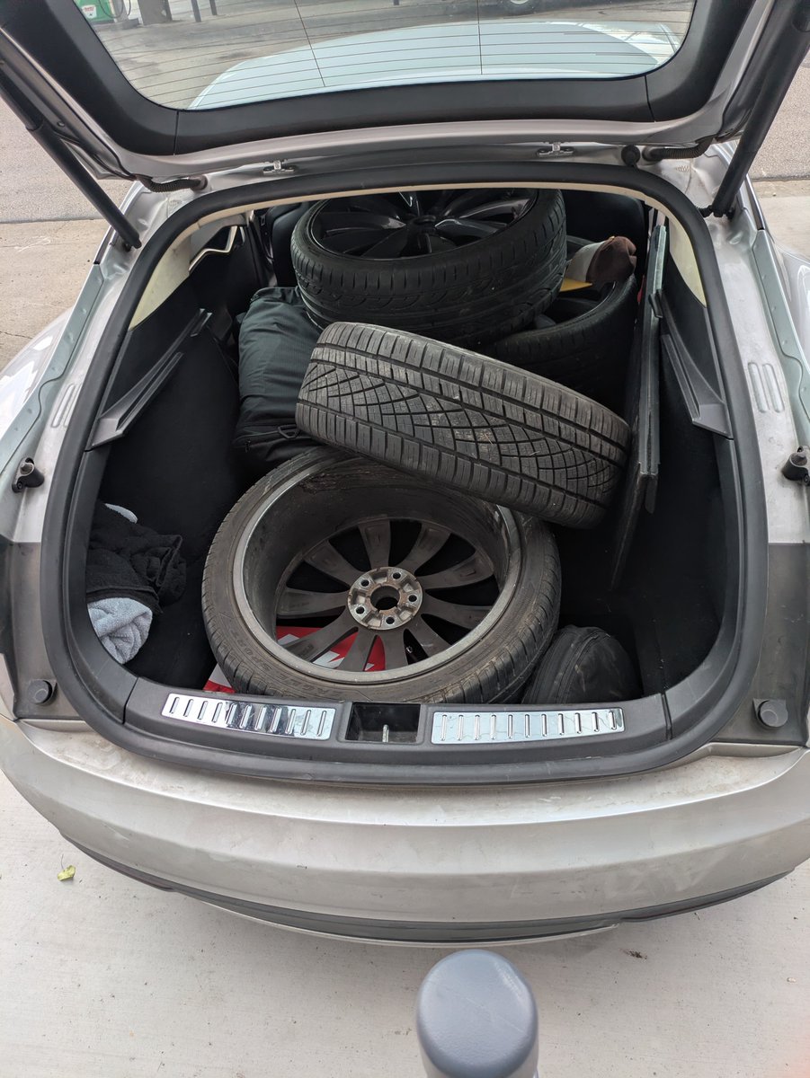 Sprapps's tweet photo. How many wheels can you fit in a 
2012 antique Tesla model s? At least five plus the four on there because I got one in the frunk too! https://t.co/dUPlWOEFEe