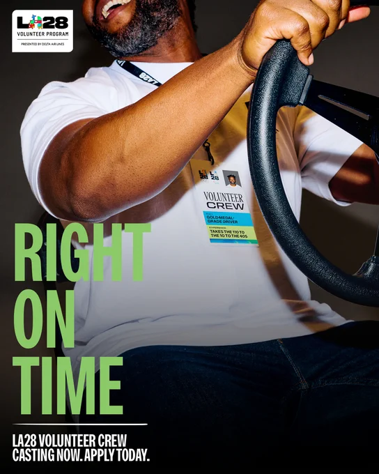 A promotional graphic for the LA28 Volunteer Crew. A volunteer is shown smiling and laughing while holding a steering wheel. Text overlay reads "RIGHT ON TIME" and "LA28 VOLUNTEER CREW CASTING NOW. APPLY TODAY."