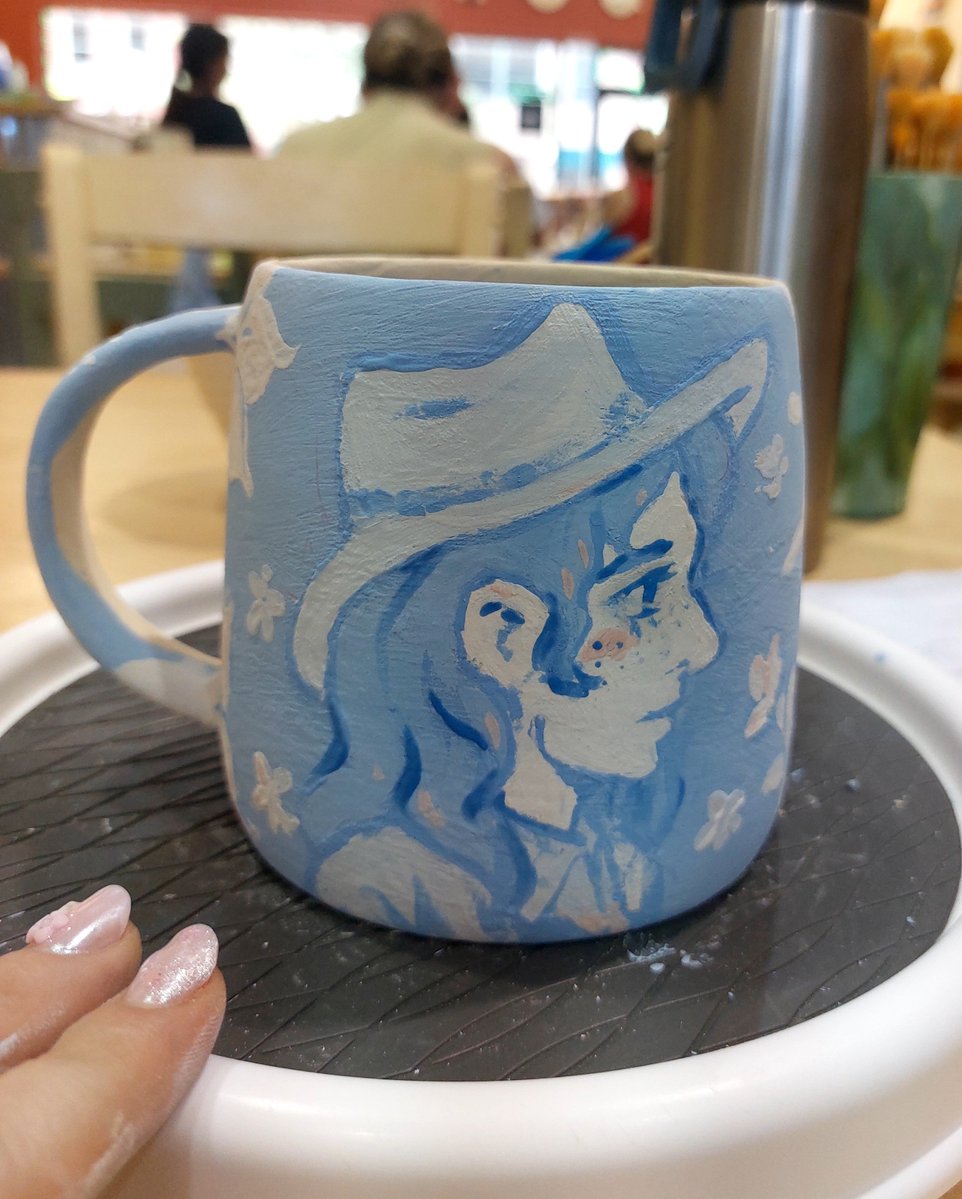 bundotcomm's tweet photo. i love making subtle merch that only makes sense to me and recently i made this #lesbyler mug with folk (polish :3) willow and cowgirl michelle. 
just waiting for it to get fired hehe https://t.co/QOUeJDpVFF