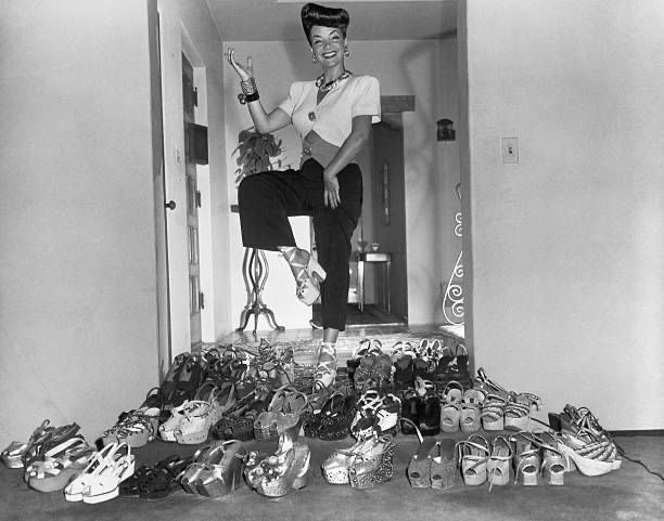 CitizenScreen's tweet photo. Carmen Miranda showing off part of her collection of platform shoes in 1944. https://t.co/HKjsImHeF9