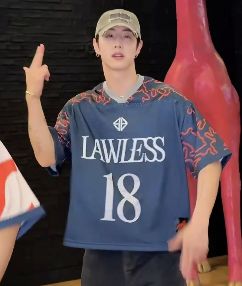 MUSExSB19's tweet photo. Aww, @marktuan looks cute in a Lawless jersey with the #SB19 logo and the number 18 🐐 

@SB19Official
#SB19 #LAWLESS 
#SB19LAWLESS https://t.co/V75IjJ2BWX