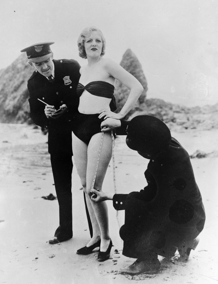 Complex's tweet photo. In the 1920s, police in several U.S. cities enforced strict beach dress codes by measuring women’s swimsuits to make sure they weren’t too revealing. 

Women who broke the rules could be fined, removed from the beach, or even arrested. Bikinis weren’t introduced until 1946, but they later faced similar bans around the world.

📸:GETTY