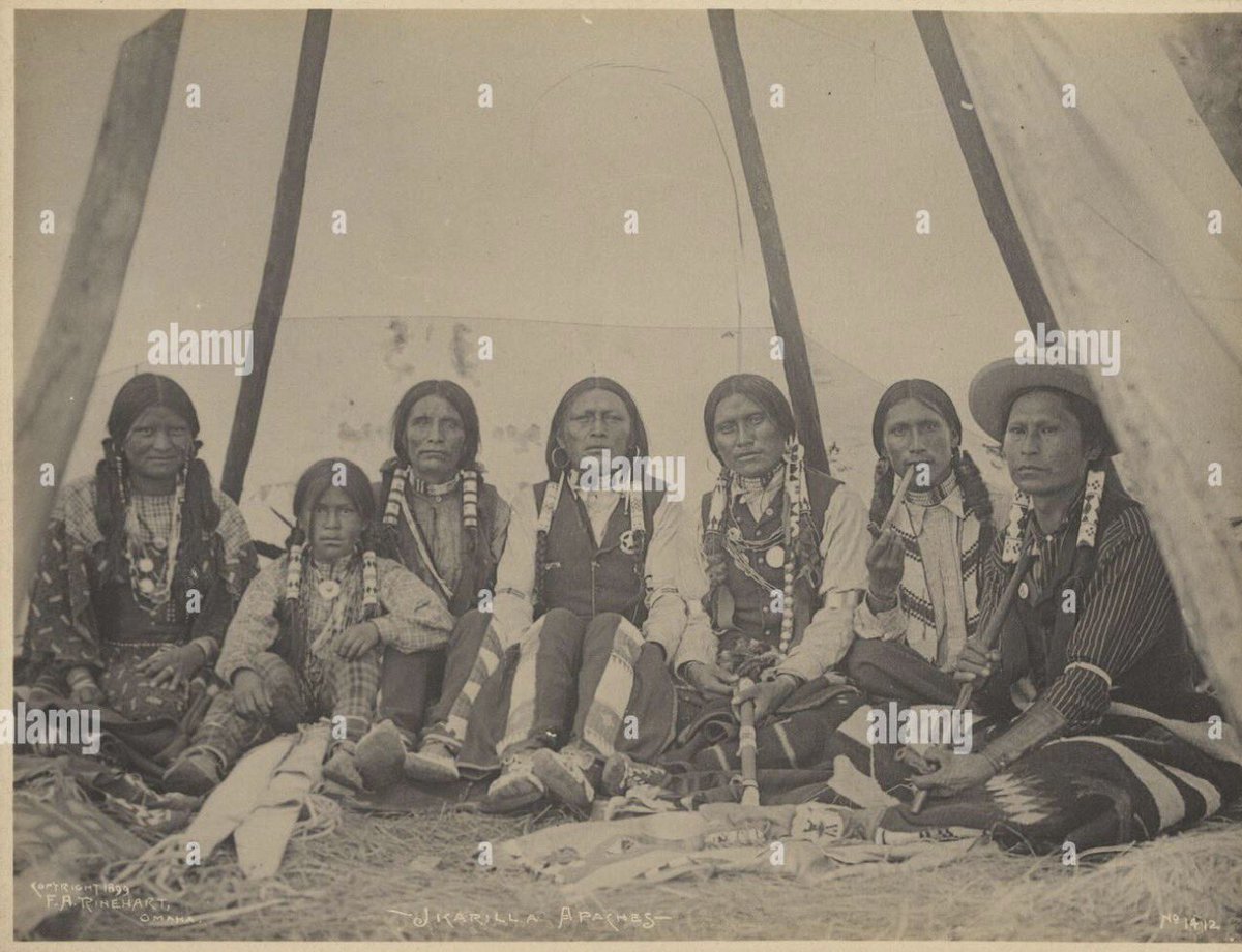 nmlinguaphile's tweet photo. Most people have never heard of the Jicarilla Apache.

They call themselves Haisndayin — “the people who came from below” — or simply Dinde, “the people.” Their language, Abáachi mizaa, is an Eastern Southern Athabaskan tongue, related to Navajo and the other Apache languages but distinct enough that speakers of one couldn’t easily understand the other. It is still spoken today, though by fewer and fewer, and the tribe has been working hard to keep it alive.

Their ancestors were Athabaskan hunters who migrated south from the subarctic between roughly 1300 and 1500, eventually settling across the high country of northern New Mexico and southern Colorado. 

Over time they formed two bands shaped by the land itself: the Olleros (“potters” or mountain-valley people) who lived west of the Rio Grande and leaned more toward farming and pottery, and the Llaneros (“plains people”) who ranged east toward the buffalo country. The two groups intermarried freely and saw themselves as one people, but the division still shapes ceremonial life.

Traditional Jicarilla religion centers on a deep connection to the land. Their chief deity, Hascin, was born of Black Sky and Earth Mother. All living things and natural features were understood as expressions of sacred power. Culture heroes like Killer-of-Enemies and Child-of-the-Water play major roles in their origin stories, and important ceremonies include the girls’ puberty rite, the Holiness Rite (sometimes called the Bear Dance), and the annual autumn relay race between the Olleros and Llaneros that was believed to influence the coming year’s food supply — plant foods if the Olleros won, animal foods if the Llaneros did.

What makes their story especially striking is how long they managed to stay free. While other tribes were being forced onto reservations in the mid-1800s, the Jicarilla largely avoided it. They intermarried with Pueblo and Hispanic neighbors, traded constantly, worked as scouts and guards, and stayed mobile enough that the government often lost track of them. They became nearly invisible by becoming essential to the frontier economy around them. Not until 1887 were they finally settled on a reservation in northern New Mexico, the last tribe in the United States to be forced onto one.

Quiet survival. Deep roots. A people who refused to disappear.

A group of Jicarilla Apache men photographed in 1899 by F.A. Rinehart.