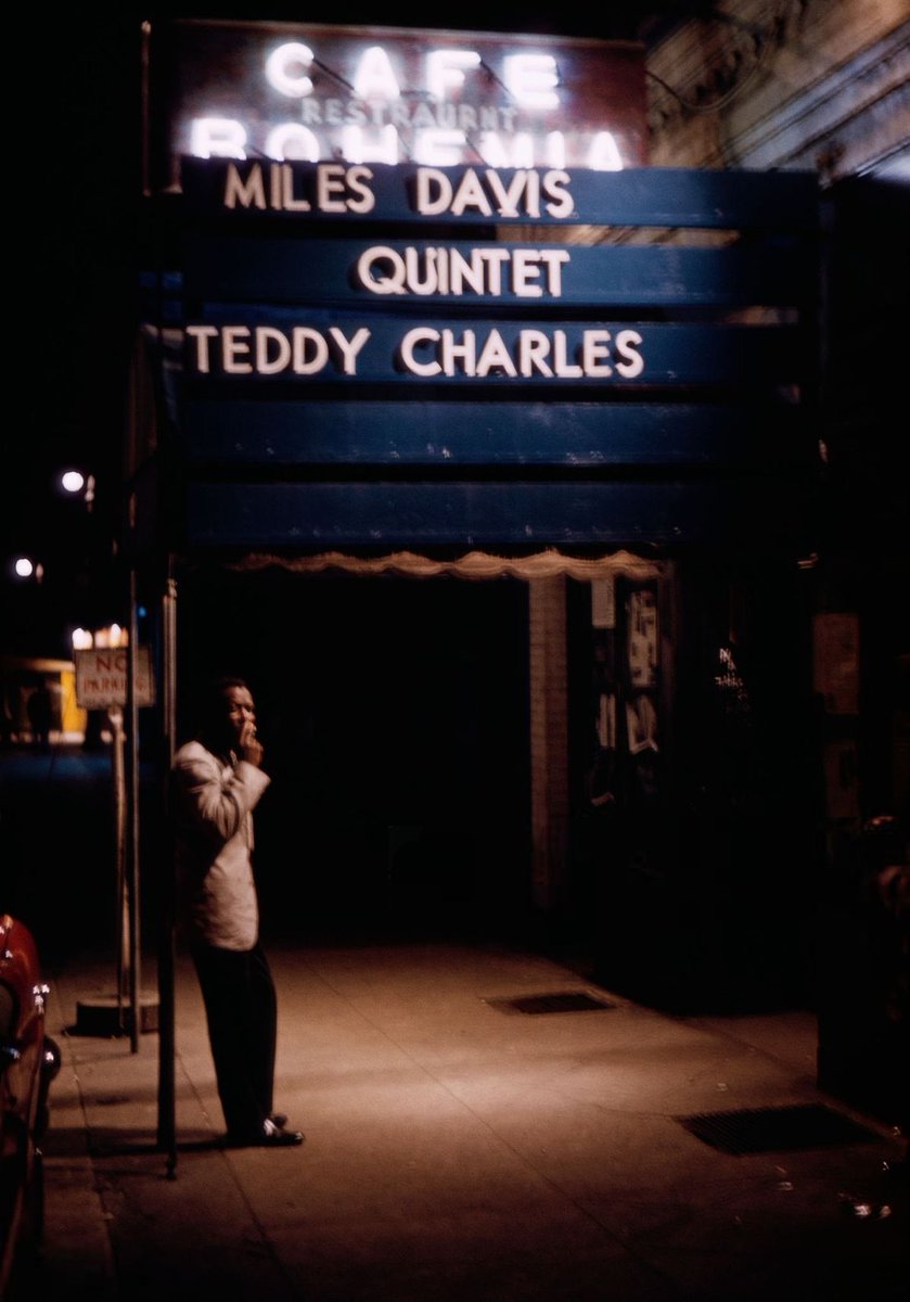SVG__Collection's tweet photo. Miles Davis smoking a cigarette under the marquee of jazz club Cafe Bohemia in New York City, 1956 (by Marvin Koner) https://t.co/07ywhQpHbs