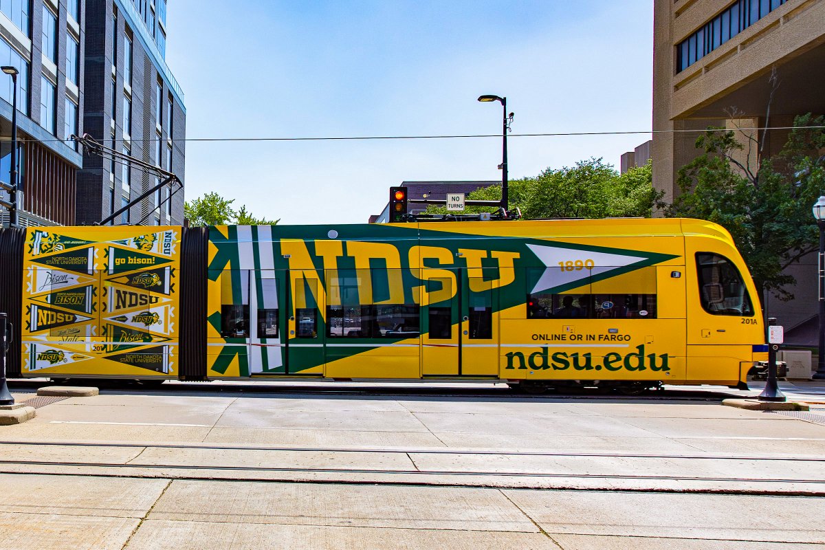 intersection_co's tweet photo. Back-to-school season is here, and @NDSU  is bringing its campus pride to Minneapolis. Through rail train wraps, the university is building awareness among those on campus, prospective students, and the broader community. https://t.co/L1WsbLKyJE