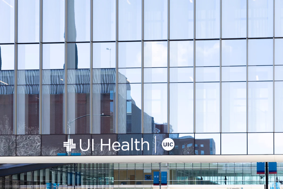 UI Health glass walkway, with UI Health and UIC logo embossed on glass.