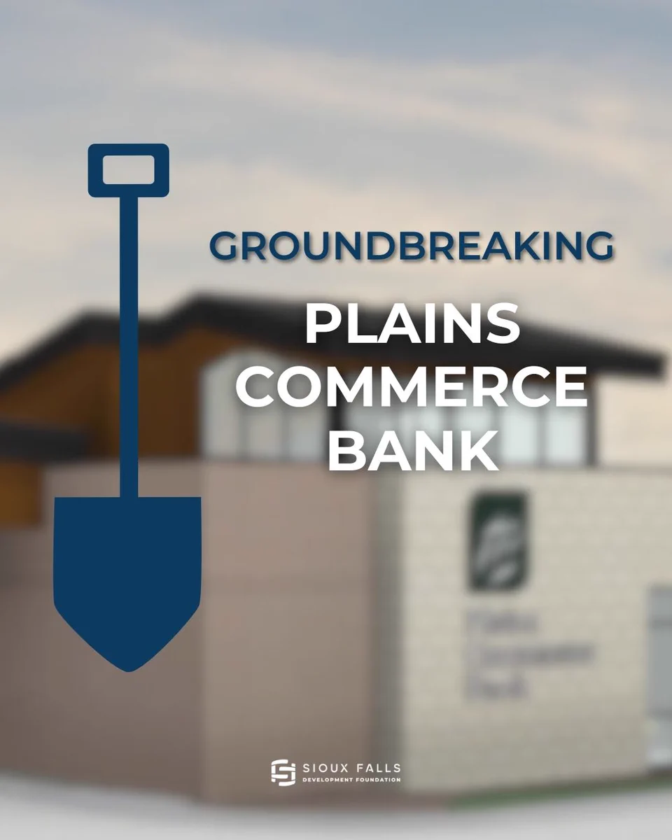 Groundbreaking announcement for Plains Commerce Bank: oversized blue shovel icon over a blurred new bank building, bold text reading "GROUNDBREAKING" and "PLAINS COMMERCE BANK," with the Sioux Falls Development Foundation logo at the bottom.