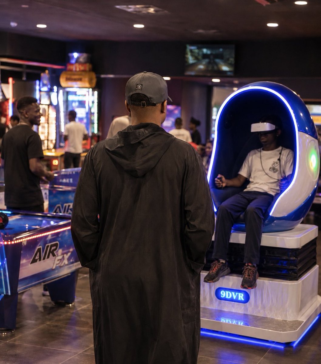 _WisdomBuchi's tweet photo. Went to this gaming house sometime ago. I took my children there to play games, and when we got there, something happened that left the whole house buzzing the whole day.

A guy brought his babe to the gaming house to play the 9D VR Simulator, which is one of those games that scares people the most…

I was carefully watching while she climbed the VR Motion Simulator Chair, and the boyfriend took a stand just beside her.

Immediately the game started, the girl started shouting and then jumped and hit her head on the floor. Fortunately for the girl, she hit the VR headset on the floor instead, and unfortunately for the guy, the VR headset broke into pieces.

His eyes first blurred 😂

In my mind, I knew there was a very big war.

When the manager came, he asked that the guy pay for the VR headset, which is over N600k.

I looked down and saw how the guy’s legs suddenly started shaking and hot sweat took over my guy.

With a faint voice, he replied, “Boss, I only have 120k in my account oo, and that’s all I have.”

Chai. I adjusted my chair.

The manager got mad and started shouting that he must pay, and if not, he would seize their phones.

When the scene became too disturbing, I stood up and met the manager. I asked him to calm down… he continued shouting, I shouted my own…

“Don’t talk while I’m talking. Listen.”

I was on my ritualist black hooded kaftan, so I was able to scare him 😂

Then I had to remind him that he didn’t put the belt meant for the game, which he was supposed to lock around the girl’s waist before even putting the VR headset on her.

So, it was his own fault.

I told him that he should be asking the guy to contribute to the replacement, not forcing him to buy a new one.

It was the manager who caused the situation, and even if you take the guy to court, believe me, I will follow you to the court to defend him.

The manager looked at my face, and I could see how suddenly his strength disappeared.

Then he asked how I thought it could be done now…

I told him to talk to the guy and see if he and his girlfriend could afford half of the money, then they should reach an agreement on how to pay.

He agreed, and then I left them to go and find my own children before they break their own 😂

Please ehhh, listen so you know why I’m telling this story.

Before you carry your woman go out, always make sure you have at least 1m Naira in your expenses account.

For you to have a girlfriend, that means you have grown…

If not, just sit your ass in the house with your babe, focus on food and make yourselves happy.

If possible, both of you should always take evening walks and then go back to the house…

That’s how me and my babe do our own, because I don’t want to sweat in an Air Conditioned room ooo.

I just want to tell new lovers so you always have it in mind.

Thankio 😏

— Wisdom Buchi