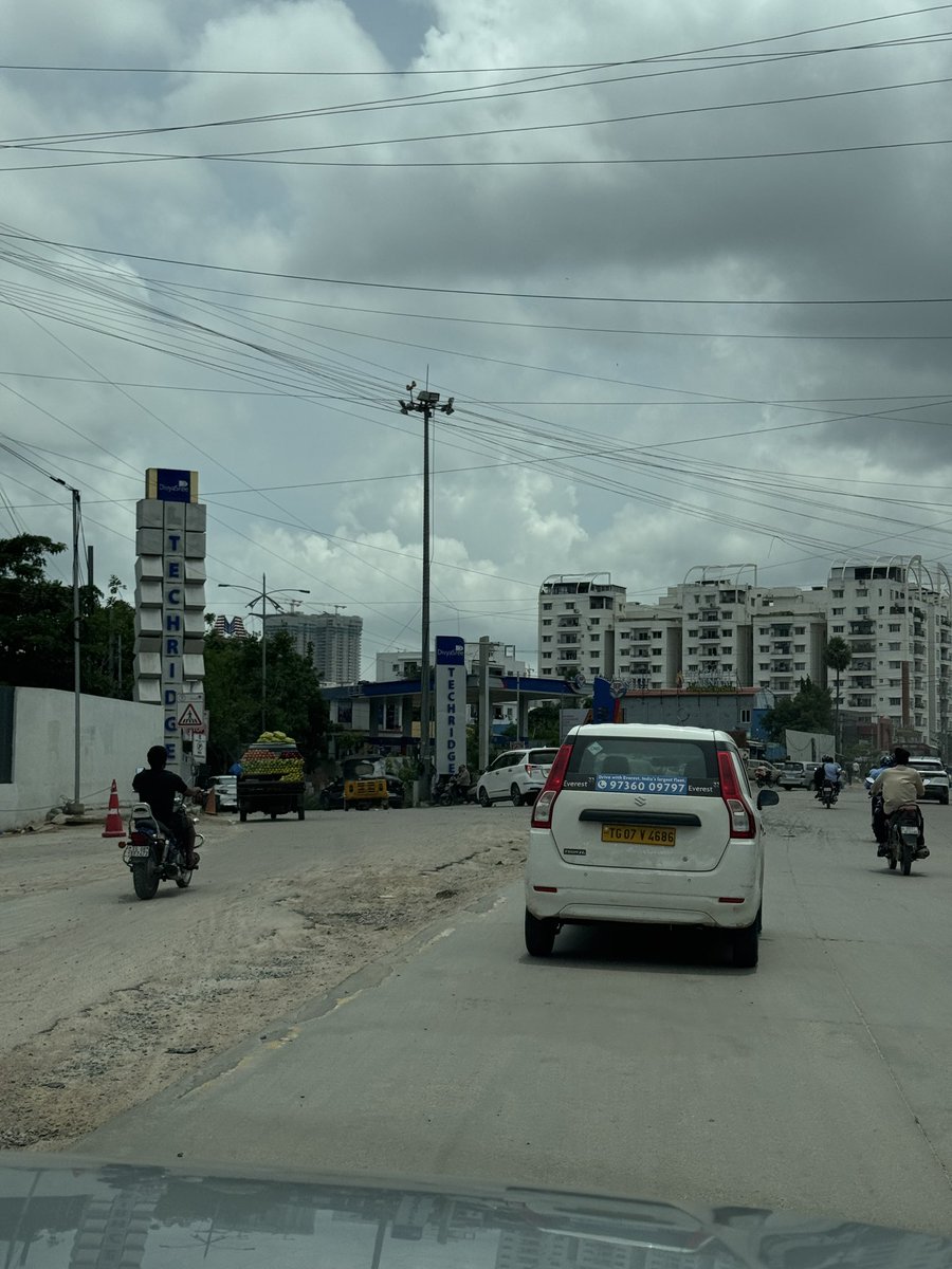 JitendraEmmani's tweet photo. This was an absolutely fine road, then dug up to lay some wires 3 weeks ago. 

It was never fixed post that, rains made it worse. 

Massive traffic jams every day due to this digging up of the road and rains on top making it worse. 

Why are the authorities letting this madness happen ?

Can this be fixed asap ??

Location: Lanco Hills Road junction, Khajaguda. 

@CMC_Offcl @CYBTRAFFIC
