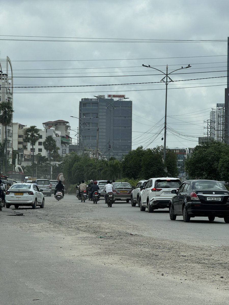 JitendraEmmani's tweet photo. This was an absolutely fine road, then dug up to lay some wires 3 weeks ago. 

It was never fixed post that, rains made it worse. 

Massive traffic jams every day due to this digging up of the road and rains on top making it worse. 

Why are the authorities letting this madness happen ?

Can this be fixed asap ??

Location: Lanco Hills Road junction, Khajaguda. 

@CMC_Offcl @CYBTRAFFIC