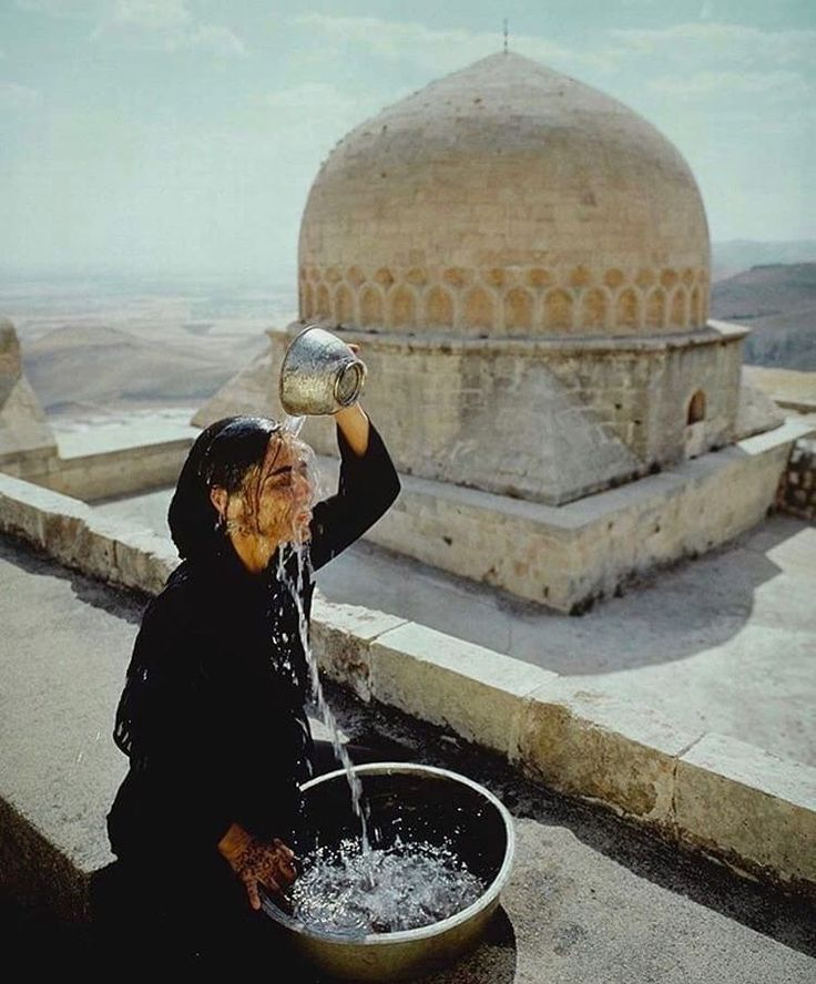 eyeonaxis's tweet photo. Water over Head, self-portrait by Shirin Neshat from the 'Soliloquy Series', shot at the historic Zinciriye Medrese complex. Mardin, Turkey, 1999 https://t.co/RAkIevOILm