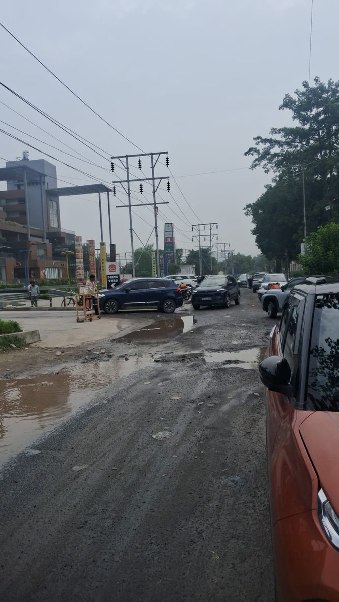 Shobhit31's tweet photo. @OfficialGNIDA side road in front of Sun twilight hs mall sector 27 is broken like anything. Rain is also creating too much damage. Kindly fix this. https://t.co/KgBM1FhmBw