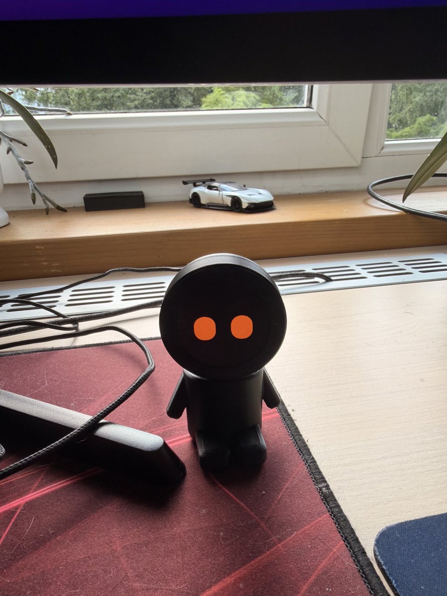 rudolfscode's tweet photo. Meet my new Desk Buddy 🤖

This is Momo, my new desk companion.

Over the weekend, I built it with an ESP32-S3, an AMOLED display, and a 3D-printed body because I thought it would look cool on my desk.

Now I’m turning it into something more: a companion that connects to the tools I use every day and reacts to what’s happening with my projects.

I’ll be building both the hardware and software in public.

I have a feeling this is going to be a fun project. 🚀