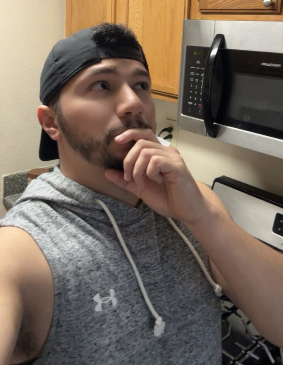 Radlobo's tweet photo. Duality of a wolf:

At work: A highly trained radiology professional, operating million dollar X-ray, CT, and MRI equipment to calculate precise anatomy scans and radiation dosage for a patient under layers of heavy lead🐺☢️. 

In the den: Just a sleeveless, smooth-brained himbo wolf locked in a deep "thinking" pose, putting 100% of his mental energy into telepathically cheering the microwave on into heating up his leftovers faster.  “You got this, little buddy!” ⚡️