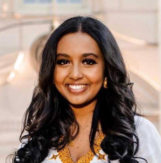 shabait's tweet photo. Grounded in History, Driven by Tech: A Diaspora Scholar’s Mission for Eritrea
By: Kidane Shimendi

Eritrean nationals living in the diaspora never stop dreaming of and contributing toward building a prosperous homeland. Ms. Yolian Ogbu is among the vibrant Eritrean youth in the diaspora tirelessly working to place Eritrean history in its rightful context and showcase the country’s rich heritage and development trajectory across the globe, particularly in the West.
Recently, she visited Eritrea to conduct field research for her PhD, focusing on Eritrea’s developmental strategy through the lens of rural solar energy projects. Eritrea Profile sat down with her for an inspiring interview about her academic journey, her advocacy, and her research.

Could you please begin by introducing yourself and sharing a bit about your background?

I grew up in the United States, raised by patriotic parents who were deeply involved in the diaspora community and actively participated in national commemorations such as Martyrs’ Day, Independence Day, and September 1st—the anniversary of the start of the armed struggle. Growing up celebrating these milestones anchored me in my Eritrean identity. I credit my parents for instilling in me the core Eritrean values and norms that continue to shape my personal vision and life goals.

While pursuing my studies in the U.S., I developed a deep passion for political science and history. I actively participated in educational competitions, debate teams, and public speaking to refine my communication skills, initially aiming to pursue a career in law. Throughout my academic journey, I constantly thought about returning to Eritrea to conduct research that would highlight the country’s true history, identity, and achievements. That drive was fueled by seeing how mainstream Western media outlets frequently disseminated misinformation about Eritrea. Studying political science and history became my way of understanding global dynamics and presenting the true image of Eritrean identity to the world.

What concrete steps have you taken so far to fulfill this personal mission?

To advance this mission, I have organized numerous educational seminars on Eritrean history, covering the period from the colonial era to the post-independence period. I also had the privilege of joining the Permanent Mission of Eritrea to the United Nations in New York, where I served as a delegate representing Eritrea at the Commission on the Status of Women for two sessions. During those sessions, I delivered speeches highlighting gender equality in Eritrea and how it was fundamentally advanced through the armed struggle. Working alongside Ambassador Sophia Tesfamariam and other experienced diplomats provided me with invaluable experience, expanding my understanding of international relations and building my confidence to engage and politically awaken young Eritreans in the diaspora.

Beyond my work with the Eritrean delegation, I engaged in broader African and global political forums through the UN platform. I traveled to Brazil as a civil society representative working with the Commission for Social Development. I traveled to Angola to conduct workshops for African and diaspora youth focusing on national development and the economic exploitation of African resources. As a political science scholar, my focus centers on addressing inequities in the international system and confronting corporate exploitation across the African continent. Fulfilling my mission for Eritrea goes hand in hand with encouraging fellow African youth to build political consciousness and pursue sovereign progress.

To counter misinformation campaigns, I regularly write articles and reports, participate in television and radio interviews, and deliver presentations to audiences comprising Western observers and the African diaspora. Currently, I am pursuing my PhD in Anthropology at the University of Chicago, where my doctoral research focuses on energy infrastructure in Eritrea.

What core values or historical legacies inspire you as you confront misinformation and engage in advocacy?

The history of the armed struggle for independence has been a profound source of inspiration for me since childhood. The immense sacrifices paid for national liberation, the resilience demonstrated against all odds, the resistance to colonial aggression, and the deep spirit of comradeship are memories I hold close to my heart. They drive my commitment to combating misinformation and raising political consciousness among diaspora youth and fellow Africans.

Above all, the national ethos of “Never Kneel” inspires my work. Looking through Eritrean history, you quickly recognize the power of the core values forged during the struggle: unity in diversity, resilience, determination, sacrifice, self-reliance, and religious harmony. These values were the ultimate assets of the Eritrean people during the struggle for self-determination, and they remain the driving force behind the nation’s contemporary development programs.

Tell us about your current PhD research thesis.

My research focuses on Eritrea’s national development strategy through the framework of renewable energy projects, specifically solar energy. The central objective is to explore and document Eritrea’s unique, sovereign development model as a valuable case study for the African continent.

While many development strategies across Africa remain heavily reliant on external aid or influenced by former colonial powers—often contributing to economic vulnerability— Eritrea pursues a sovereign, self-determined model. It prioritizes rural development and basic social services. When traveling across the country, the equitable distribution of essential services—such as education, clean water, healthcare clinics, transport, and energy supplies in rural communities—is clearly visible. Rather than relying entirely on foreign aid or external experts, these initiatives are planned and executed using local capacity, skills, and strategies.

Self-reliance is the bedrock of this model. It is an approach forged during the liberation struggle that continues to guide the nation-building process today. Unlike policy frameworks imposed from the outside, self-reliance in Eritrea is a culturally embedded practice. It is even reflected in long-standing Tigrinya proverbs, such as “The one who relies on others wears out like a shoe” or “Begging turns a person into an ape,” demonstrating how autonomy is woven into the national identity.

I specifically chose solar energy for my field study to examine how Eritrea is deploying clean energy technology in rural areas as part of its national strategy. As climate change and sustainable energy become central global topics, sharing Eritrea’s practical experiences in local energy management offers meaningful insights for economic independence across Africa.

Finally, what message would you like to share with Eritrean youth at home and in the diaspora?

Let us stay conscious, organized, and equipped!

One of the most powerful principles from our history is summed up in the spirit of “Never Kneel” and the classic adage, “The dogs may bark, but the camel continues its march.” In a rapidly changing global landscape, we—especially the youth—must remain grounded in our history and continually build our political consciousness. It was national consciousness and unity that secured victory in the struggle for independence against incredible odds, and it is that same strength that will enable us to build the prosperous nation we envision.

Ms. Yolian, thank you for sharing your time and insights with us, and we wish you continuous success in your academic and professional endeavors.