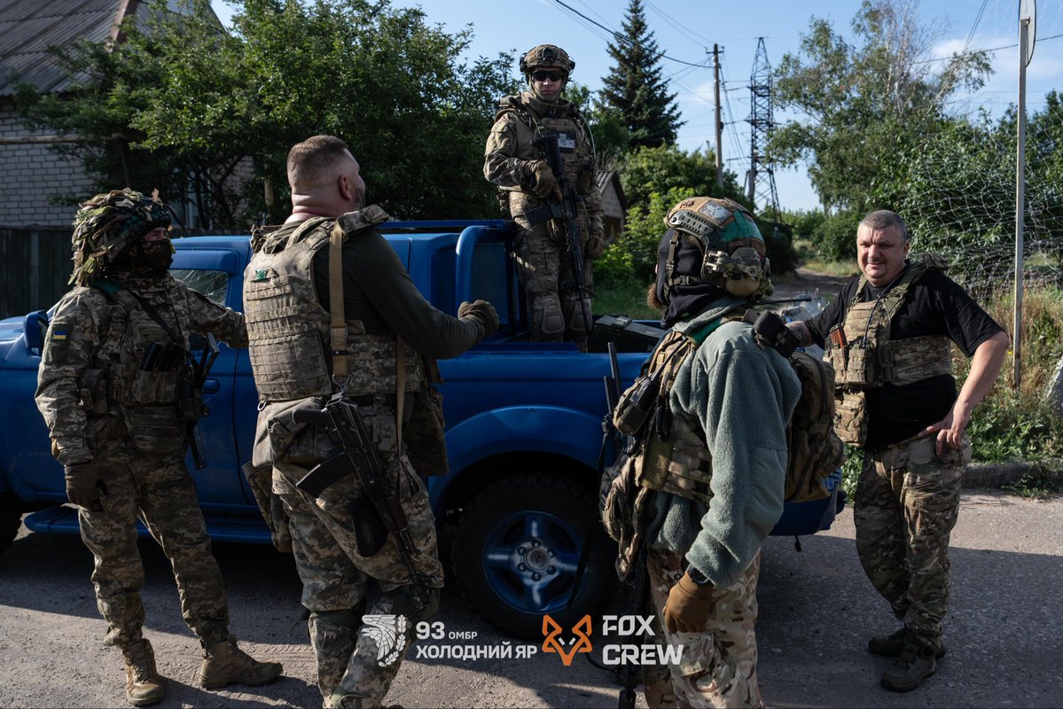 93OMBr1's tweet photo. These are some of the men cutting off russian logistics, leaving the occupiers without food, ammunition, and even water.

Fox Crew began the war as anti-tank teams, helping stop russian armored columns during the early stages of the invasion. Later, they transitioned to fiber-optic strike drones, which they continue to use extensively. Now they are mastering a new drone system with an entirely different communications link, capable of flying deep behind enemy lines. These drones are highly resistant to enemy electronic warfare, while providing a clear, stable video feed.

Their "office", tucked away in the middle of a dense tree line, consists of several computers and monitors. The new drones are prepared for launch. The battery is fully charged –it's time to fly.

Fifteen minutes later, the drone has crossed the front line and reached a distant village somewhere between Kostiantynivka and Pokrovsk, where it begins patrolling the streets in search of targets.

The sun rises over the sunflower fields of Donbas.
Meanwhile, another Fox Crew platoon is carrying out a logistics mission, delivering supplies and ammunition to front line positions by ATV. An evacuation team remains on standby near the Kramatorsk–Kostiantynivka highway. From there, they can walk to the Kramatorsk city sign, where burned-out ATVs and ground robotic systems lie scattered beneath it. If anything goes wrong, they are ready to head out immediately and evacuate the soldiers operating closer to the front.

Less than half an hour later, the roar of ATV engines and a pickup truck echoes down the road. The resupply mission has been completed successfully, and fortunately the evacuation team was not needed today.

On their way, the soldiers destroyed a waiting enemy FPV drone lying in ambush. Now they sit together, smoking and animatedly discussing what was a stressful, but ultimately successful mission.