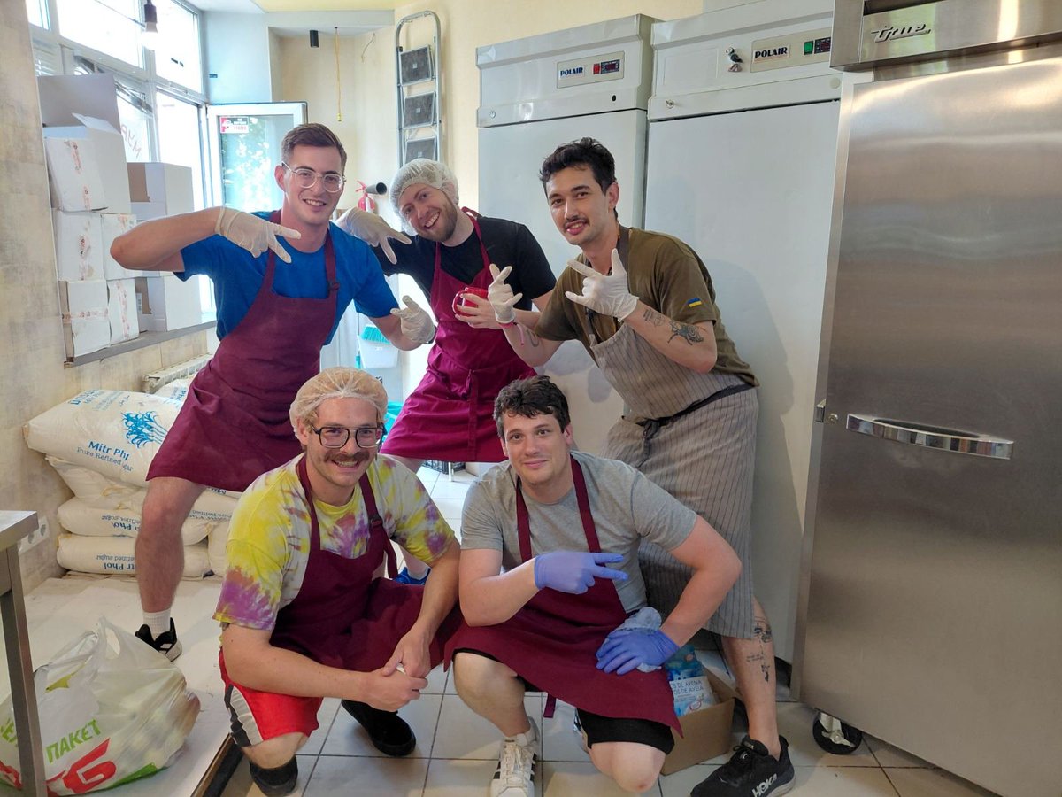 ants_kyiv's tweet photo. At Ants Kitchen Hub, international volunteers work side by side with Ukrainians on a daily basis 🇺🇦🌎

🇺🇸 Ben (blue T-shirt) is from the USA, but lives in Tokyo. He liked it here so much that he told his friends (John and Phil, squatting) about our kitchen, and they came, too! 
🇩🇰 Nicklas (black T-shirt) is from Denmark, it's his first time here.
🇫🇷 Alex is from France, he's been to Ants Kitchen multiple times. He's also volunteered with other organizations in different Ukrainian cities.

💛 New volunteers are always welcome and appreciated here. If you decide to join us, you'll have the chance to not only help our cause, but also meet many interesting, inspiring, brave, lovely people, as well as explore the city of Kyiv with its rich history, culture and architecture. The level of risk here is not zero, but quite low.

🧳 If you'd like to come work with us, please fill in this form. The coordinator of Ants International Legion will contact you soon and provide the necessary information and support before and during your trip.
https://t.co/1eTAvfYfYH