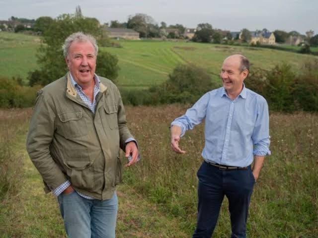 SamaHoole's tweet photo. Jeremy Clarkson calls his land agent Cheerful Charlie because the man has never once brought him good news. Five series. Not a single piece of it.

Watch the pattern and it stops being a running joke.

Clarkson has an idea. Charlie opens the folder. The idea costs more than it earns, or the yield will not carry it, or the rules do not allow it, or the money runs out in March. Clarkson goes ahead anyway. Charlie is right. Nobody thanks him, and next episode the same thing happens again.

Now notice what he is actually doing in every one of those scenes. He is not being pessimistic. He is reading out the arithmetic of British farming to a man who does not want to hear it, and the arithmetic never says yes.

The nickname is a joke about Charlie's manner. It is a description of the industry.

Because look at what the job now consists of. Harper Adams lists what a land agent has to handle: planning law, agricultural management, budgeting, finance, construction, property law, machinery purchasing, valuation and negotiation. Nine trades. Charlie has an agriculture degree from Nottingham, is a registered agricultural valuer and a qualified agronomist, spent years at Strutt and Parker, has over two decades in the field and is a partner at Ceres Rural.

Clarkson could have hired anybody in Britain. He hired the real thing in 2019, and the real thing has spent five years saying no.

That is the state of it. The best-qualified man on the farm, applying twenty years of training to a thousand acres, and the professional answer is almost always that it will not work.

Then the bit that turns the whole story over.

Harper Adams says applications and open day numbers on its Land and Property Management course have felt a ripple effect from the show, and their lecturer names Charlie as the reason. He praised exactly the thing Clarkson mocks him for: the no-nonsense approach, the refusal to dress anything up.

So a generation of teenagers watched a middle-aged man deliver bad news on television for five years, and a chunk of them thought, that is the job I want.

Not the tractor. Not the pub. Not the fame.

The folder.

They watched somebody be quietly, unglamorously right in a room full of people who did not want to hear it, and they recognised it as a kind of competence worth having. That is a better advert for a profession than any campaign has ever managed, and nobody designed it.

Every trade in this country has a Charlie. The one who tells you what it will actually cost, who gets ignored, and who turns out to be right in about eight weeks.

He is never the one they make the programme about.

He is the reason there is a farm left to film.