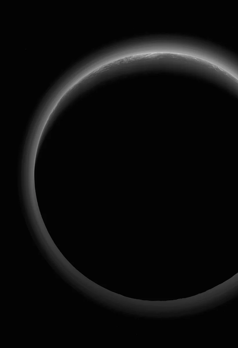 NASA’s New Horizons spacecraft took this stunning image of Pluto only a few minutes after closest approach on July 14, 2015. The image was obtained at a high phase angle –that is, with the sun on the other side of Pluto, as viewed by New Horizons. Seen here, sunlight filters through and illuminates Pluto’s complex atmospheric haze layers. Credit: NASA/JHUAPL/SwRI