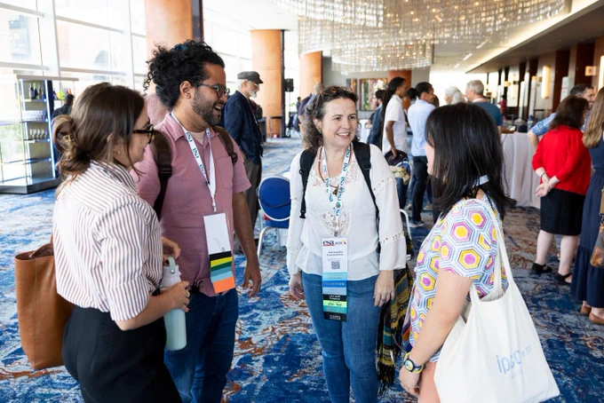 a group of ecology graduate students and early career faculty share a joke at a reception for ESA award winners