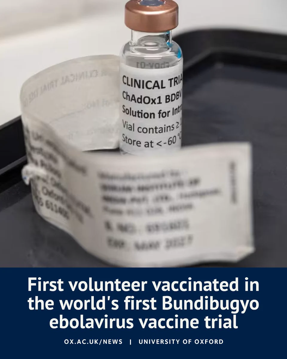 Close-up of a vial labelled for a clinical trial vaccine on a laboratory tray, with an overlaid headline reading “First volunteer vaccinated in the world's first Bundibugyo ebolavirus vaccine trial” and University of Oxford branding.