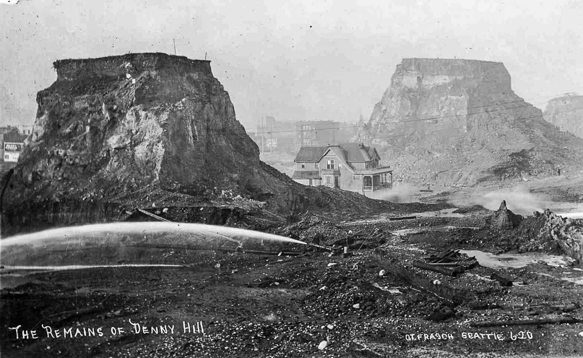 EchoesofWarYT's tweet photo. Most people have no idea that downtown Seattle used to have a hill the size of a 20 story building sitting right in the middle of it.

Denny Hill. 220 feet tall. The city looked at it and decided to just get rid of it. Not tunnel through it. Not build around it. Erase it completely.

So they pointed giant water cannons at the hill and blasted it apart with pressurized water, then washed the mud down into Puget Sound. It took them from 1897 to 1930 and they moved more than 11 million cubic yards of dirt. An entire hill, hosed into the bay.

And here is the part that sounds made up. Some homeowners refused to sell. So the engineers just carved the hill away around them. That left houses stranded on top of skinny towers of dirt, some of them a full hundred feet in the air, reachable only by a long wooden staircase. People called them spite mounds. The holdouts all caved eventually, and those last pillars got washed away too.

Now go to Chicago. In the 1850s the whole city was basically a mud pit with no drainage, so they made a decision that is hard to even picture. They raised the entire city. They put thousands of jackscrews under entire brick buildings and slowly cranked them up out of the mud, sometimes 6 feet or more. In 1860 they lifted half a city block, 320 feet of solid masonry weighing 35,000 tons, up almost 5 feet in five days, and the stores stayed open the whole time. People shopped inside while the building rose under their feet. They even jacked up a six story hotel with the guests still sleeping in it.

Boston did the opposite. The city was originally a bumpy peninsula with three big hills, which is why the main road is still called Tremont, from Trimountain. They sheared the tops off those hills, dropping the summit of Beacon Hill by around 60 feet, and used the dirt to fill in the harbor and the marshes. A huge chunk of downtown Boston is standing on ground that used to be the hills, and other parts are standing on what used to be open water.

Kansas City was so hilly and muddy they nicknamed it Gully Town, so they cut down bluffs 100 feet tall and dumped them into the ravines to flatten the place out. Los Angeles sliced whole hills out of its downtown to make room for the city core.

We walk around these cities assuming the ground was always shaped like this. It wasn't. Enormous parts of urban America were carved down, blasted apart, jacked up, and washed into the sea by men with hoses, shovels, and hand cranks, and most of it happened barely a hundred years ago.

The land you are standing on is not the land that was there.