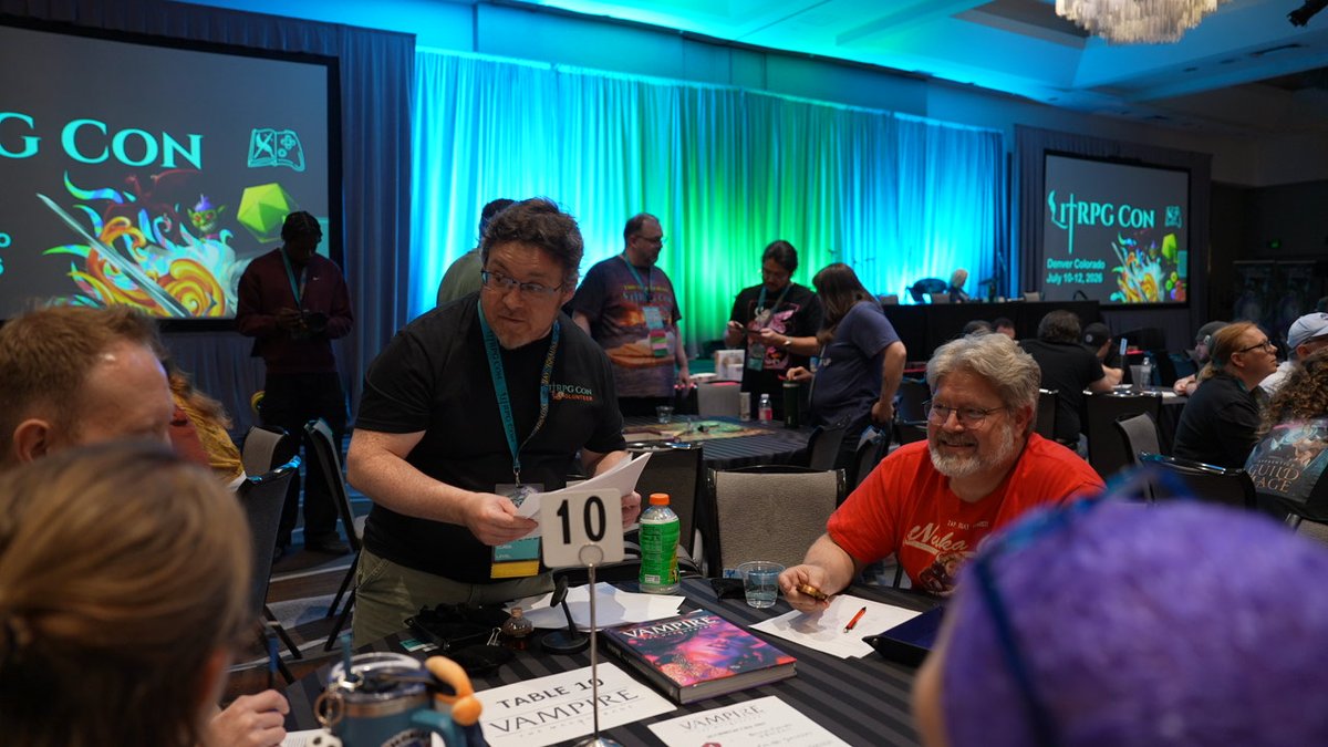 AudibleACX's tweet photo. We hosted a happy hour at #LitRPGCon2026 and honestly? One for the books.

Authors, narrators, friends & Audible/ACX team hanging out, swapping stories, and celebrating this ridiculously supportive community.

We also sponsored the gaming room—doubling the tables, so fans could play tabletop games WITH the creators behind their favorite audiobooks.

That's the kind of community we're here for 🧡🎲📚🎧